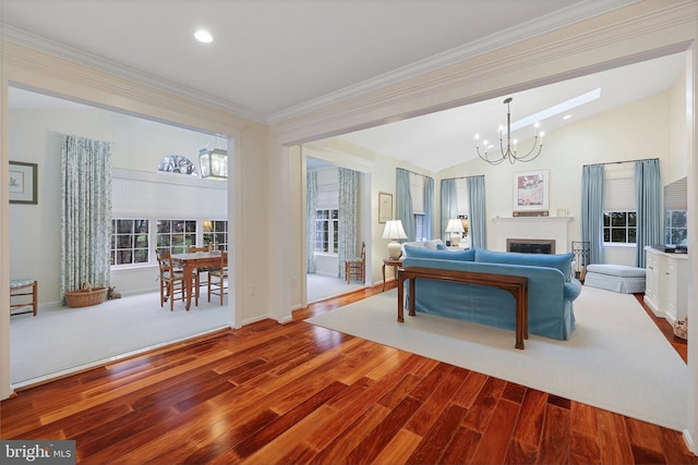 interior space featuring hardwood / wood-style flooring, crown molding, a chandelier, and vaulted ceiling