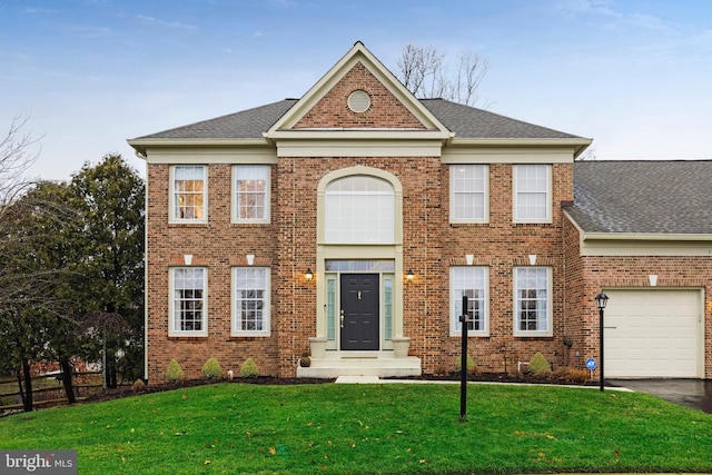 colonial inspired home featuring a front yard