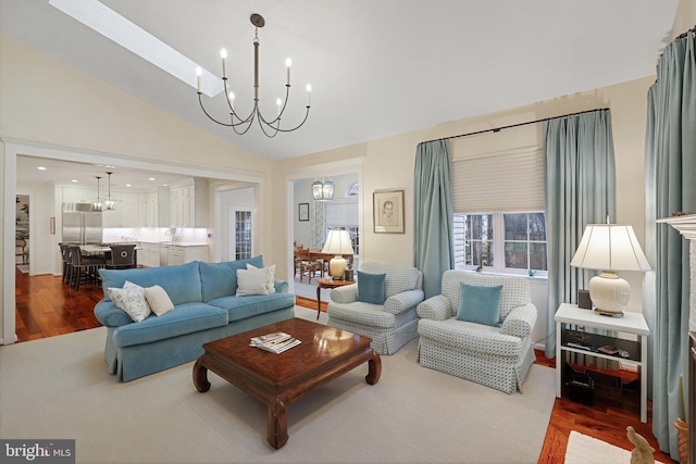 living room featuring hardwood / wood-style flooring, vaulted ceiling, sink, and a chandelier