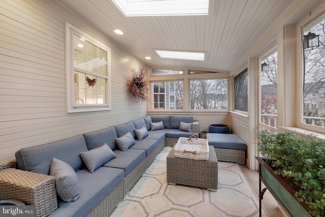 sunroom with lofted ceiling with skylight and wooden ceiling