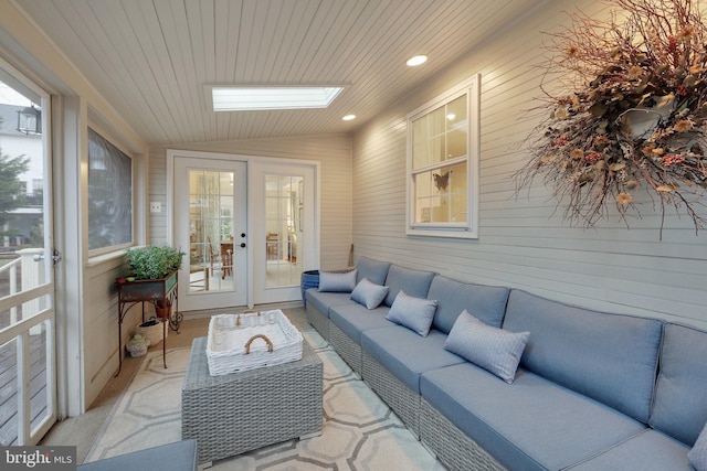 sunroom with wood ceiling, lofted ceiling with skylight, french doors, and a healthy amount of sunlight