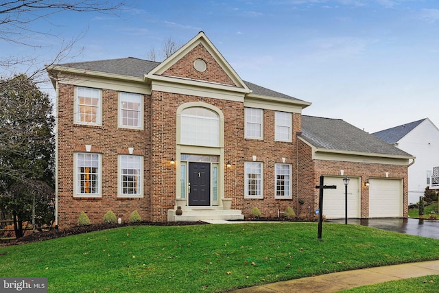 view of front of house with a garage and a front lawn