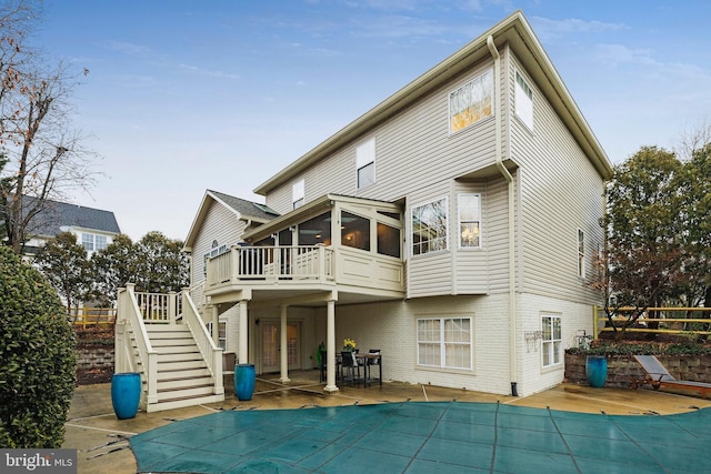 back of property with a patio, a sunroom, and a pool side deck