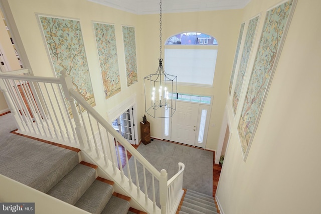 foyer entrance featuring an inviting chandelier and a high ceiling