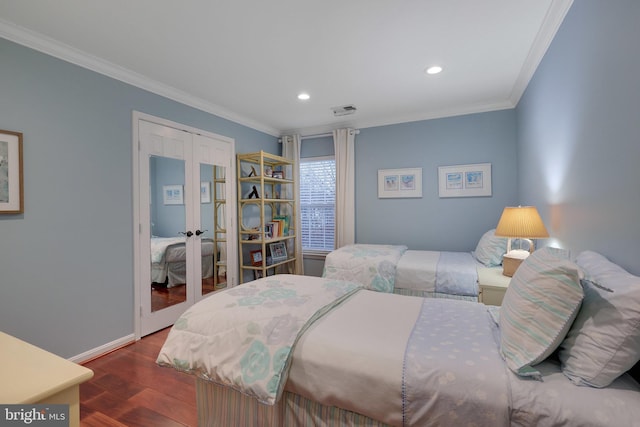 bedroom with ornamental molding, dark hardwood / wood-style flooring, and french doors