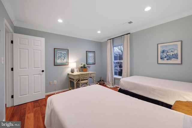 bedroom with crown molding and dark hardwood / wood-style floors