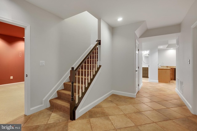 stairway featuring tile patterned floors