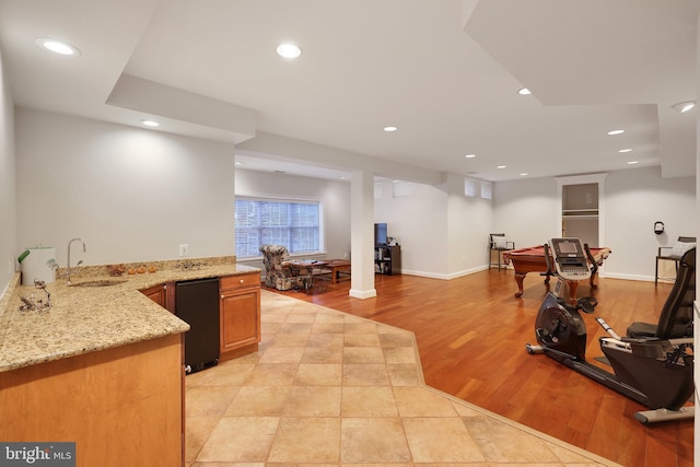 workout area with sink and light hardwood / wood-style flooring