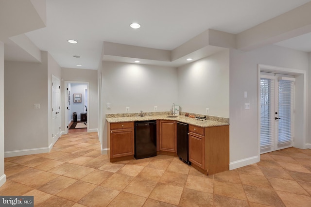 kitchen featuring dishwasher, sink, and light stone counters