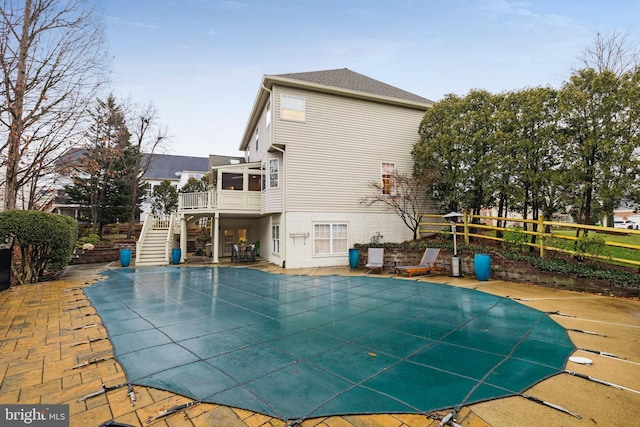 view of pool featuring a patio and a sunroom