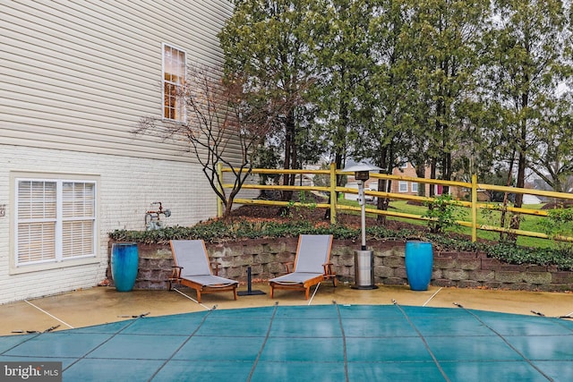 view of patio featuring a covered pool