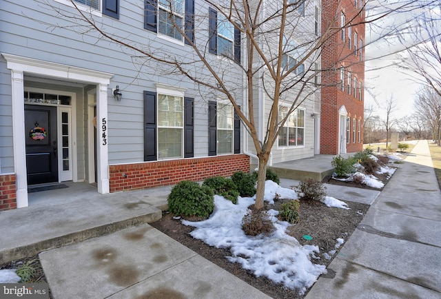 view of snow covered property entrance