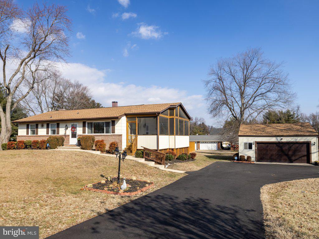 view of front of house with a garage and a sunroom