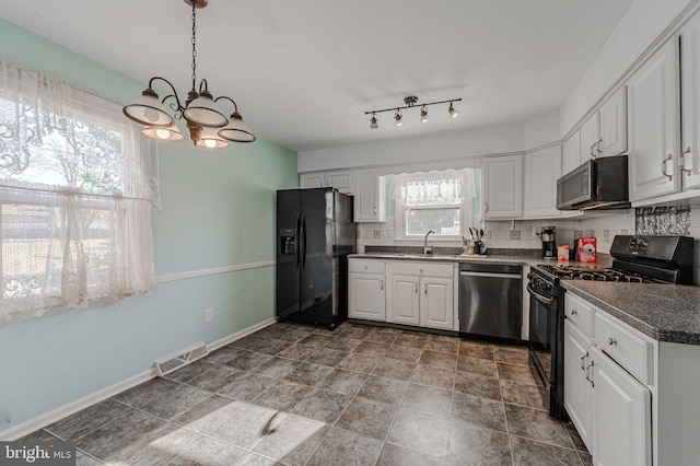 kitchen with sink, hanging light fixtures, black appliances, white cabinets, and decorative backsplash