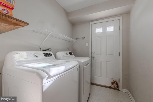 washroom with independent washer and dryer