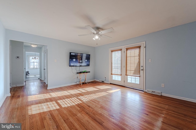 unfurnished living room with ceiling fan and light hardwood / wood-style floors