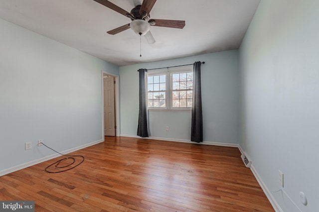 spare room with ceiling fan and hardwood / wood-style floors