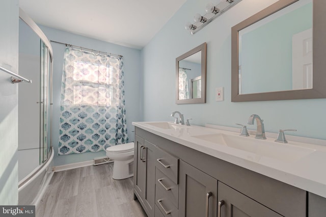 full bathroom featuring vanity, hardwood / wood-style floors, shower / bathtub combination, and toilet