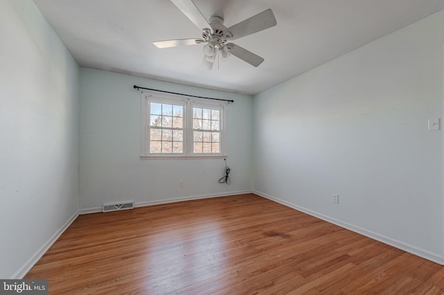 unfurnished room with ceiling fan and light wood-type flooring