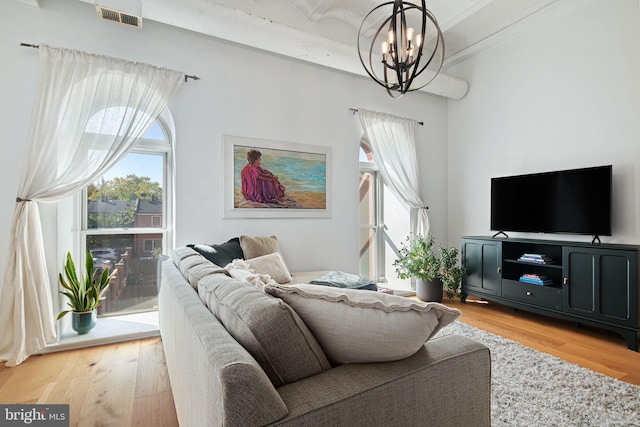 living room with an inviting chandelier and hardwood / wood-style flooring