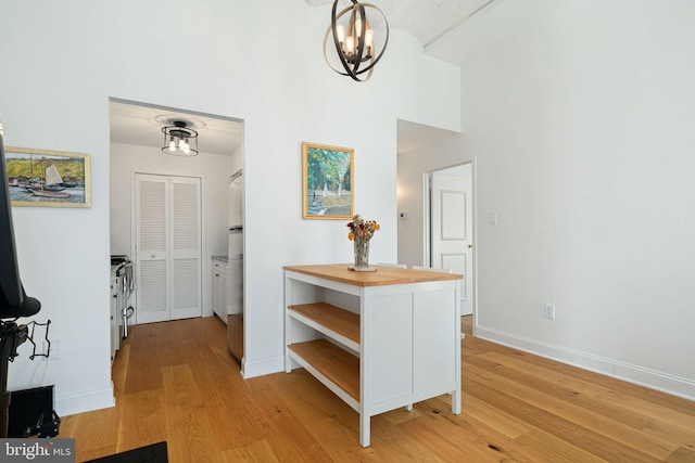 hallway featuring a high ceiling and light hardwood / wood-style flooring