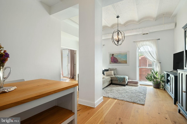 interior space with an inviting chandelier and light hardwood / wood-style flooring