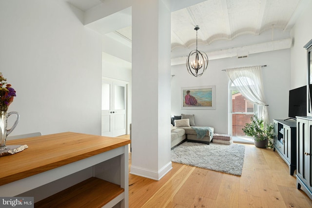 interior space featuring an inviting chandelier, brick ceiling, and light wood-type flooring