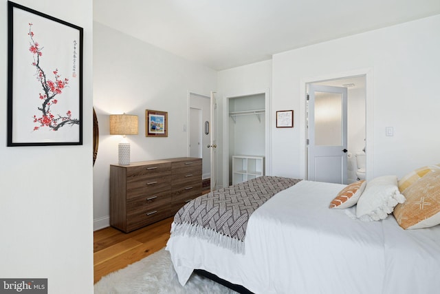 bedroom with hardwood / wood-style floors and a closet