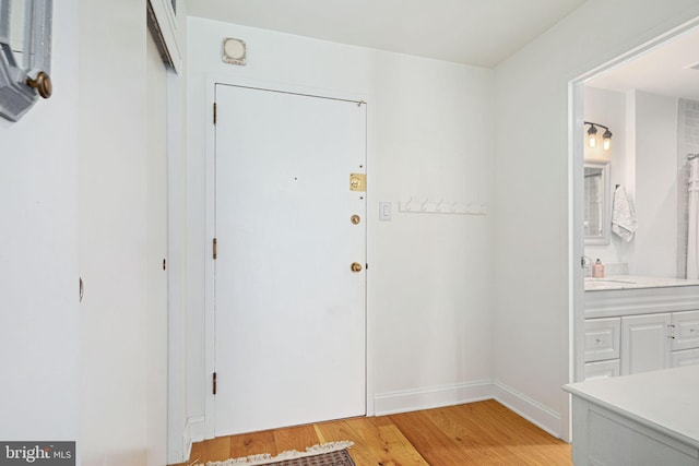 entrance foyer featuring sink and light hardwood / wood-style flooring