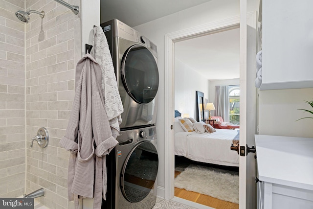 clothes washing area featuring stacked washer and dryer