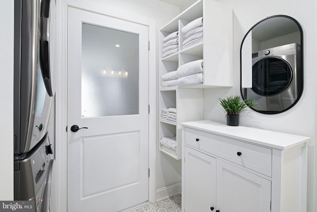 interior space featuring cabinets and stacked washer and dryer