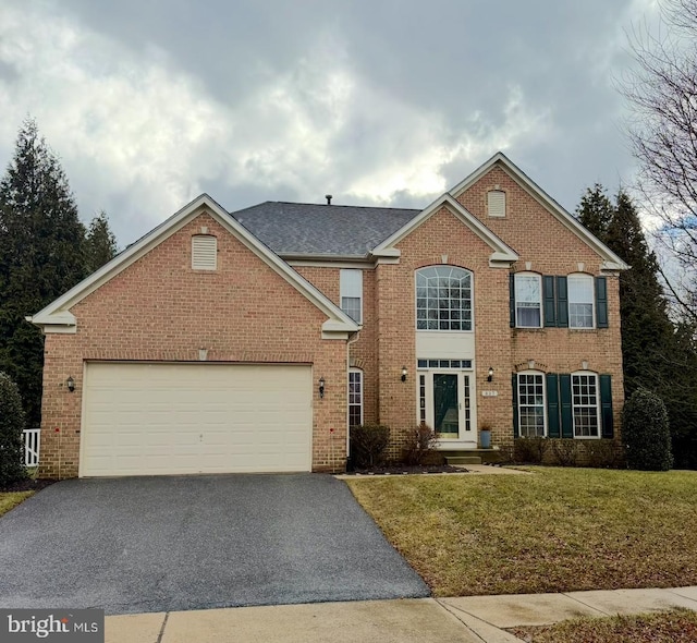 view of front property with a front lawn and a garage