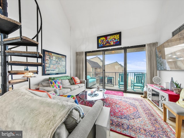 living room featuring a towering ceiling