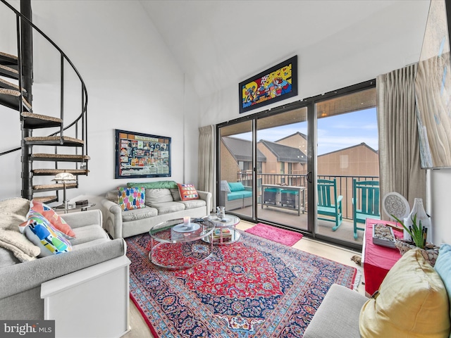 living room with high vaulted ceiling