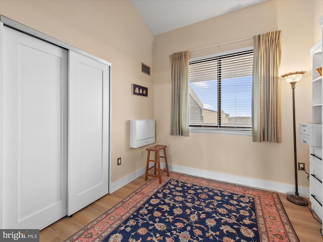 bedroom featuring hardwood / wood-style floors and a closet