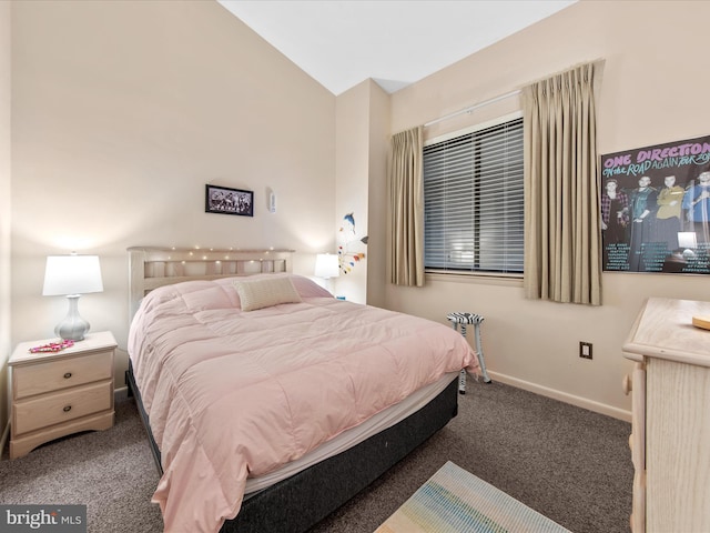 bedroom with vaulted ceiling and dark colored carpet