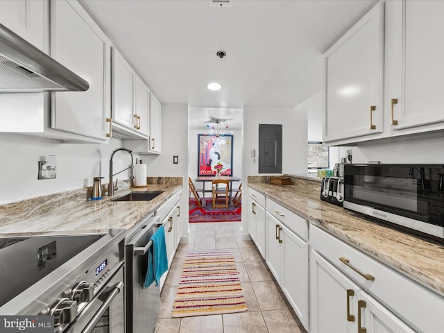 kitchen with stove, sink, white cabinetry, and range hood