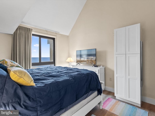 bedroom with vaulted ceiling and wood-type flooring