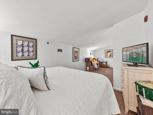 carpeted bedroom with vaulted ceiling and a textured ceiling