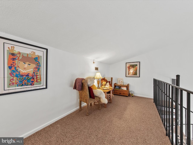 sitting room with lofted ceiling and carpet floors