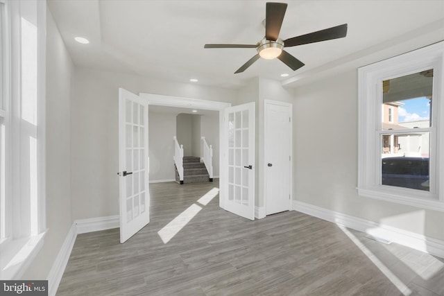 spare room featuring french doors and hardwood / wood-style floors