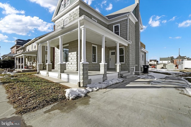 view of side of home with a porch