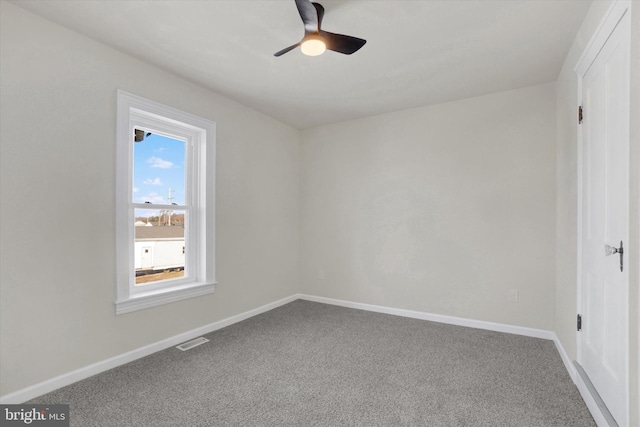 unfurnished room featuring ceiling fan and carpet