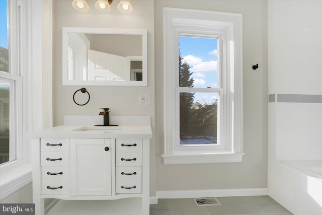 bathroom featuring tile patterned floors, vanity, and a bathtub