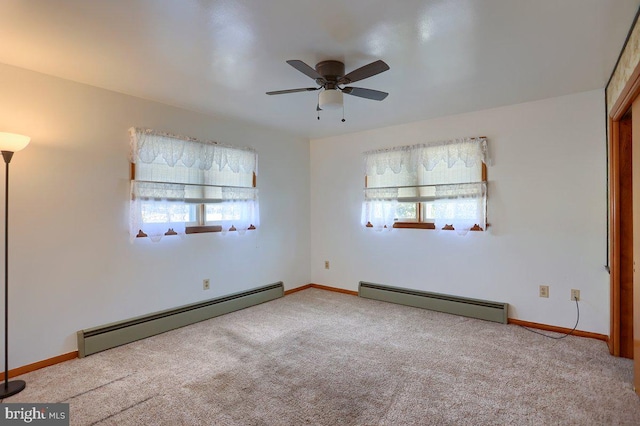 carpeted spare room with a baseboard radiator and ceiling fan