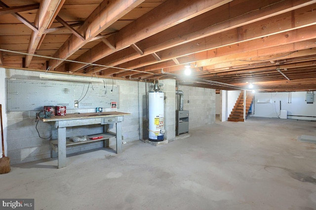 basement with gas water heater, a workshop area, and electric panel