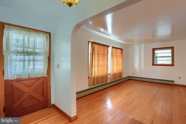 entryway featuring baseboard heating and light wood-type flooring