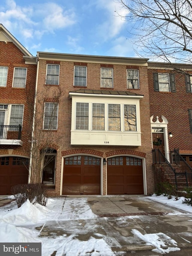 townhome / multi-family property featuring a garage