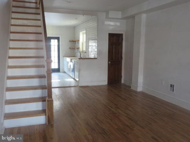 unfurnished living room featuring hardwood / wood-style flooring