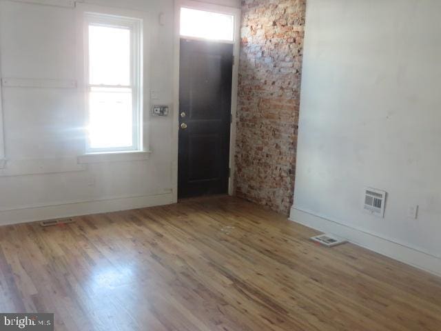 foyer featuring plenty of natural light and hardwood / wood-style floors